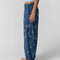 side view of model wearing navy pinstripe balloon lounge pants with white dainty floral print