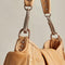 up close of tan saddle bag crossbody with silver hardware