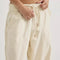 up close of model wearing cream relaxed fit jeans with elastic waist and drawstring