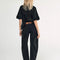 back view of model wearing washed black barrel jeans