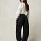 back view of model wearing washed black barrel jeans