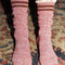 up close of model wearing red and white marled knee high socks with double burgundy stripe top and white ruffles