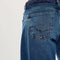 up close of back of model wearing low rise dark denim barrel jeans