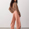 back view of model wearing dessert pink barrel pants