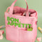 light pink lunch bag with lime green 'bon appetit' across the front