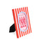 side view of coral orange and light pink vertical stripe photo frame with periwinkle frame around the photo