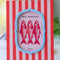 coral orange and light pink vertical stripe photo frame with periwinkle frame around the photo on a table