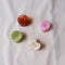 round honey brown, round matcha with carved lines, heart-shaped cream shell, and flower-shaped pastel pink.