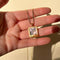 model holding gold polaroid photo charm necklace