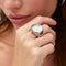 model wearing silver watch ring