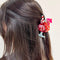 model wearing strawberry daiquiri drink hair claw