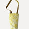 two tone yellow dots wine tote with olive green strap laying flat