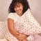 model holding light pink cherry print satin pillowcase