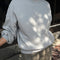 model wearing heather grey relaxed fit french terry sweatshirt