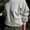 model wearing heather grey relaxed fit french terry sweatshirt