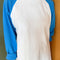 model wearing relaxed fit raglan tee with light blue sleeves