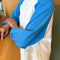 side view of model wearing relaxed fit raglan tee with light blue sleeves