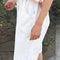 side view of model wearing white cotton relaxed fit bermuda shorts