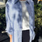 model wearing relaxed fit blue and white vertical stripe button front shirt