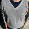 front view of model wearing light grey v-neck sweater