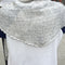 back view of model wearing heather grey pointelle square shawl with scalloped edges