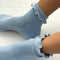 model wearing periwinkle ruffle socks
