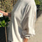 side view of model wearing naturel cotton long sleeve tunic with mockneck