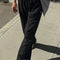 model wearing black cotton straight leg pants