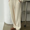 model wearing cream waffle knit pants with elastic waist and side pockets