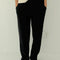 model wearing black waffle knit pants with elastic waist and side pockets