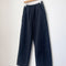 washed black cotton pants on a hanger