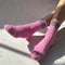 model wearing bubblegum pink socks with green stripe cuffs