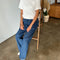 model wearing white organic cotton tee with slight distressing on the sleeves and neckline