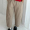 model wearing khaki arc pants with side pockets and side leg panels