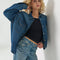 model wearing dark denim relaxed shit button down shirt with patch pockets in the front