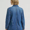 back view of model wearing blue relaxed fit chore jacket with faint pinstripes, white bleach splatters and patch pockets