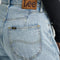 up close of model wearing medium wash loose crop button fly jeans