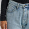 up close of model wearing medium wash loose crop button fly jeans