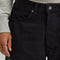 up close of model wearing black loose crop button fly jeans