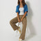 model wearing tan brown slouch chino pants with pleated front
