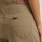 back view of model wearing tan brown slouch chino pants with pleated front