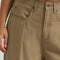 up close of model wearing tan brown slouch chino pants with pleated front