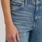 up close of model wearing classic straight leg jeans with medium gritty wash with distressing on the knees