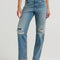 model wearing classic straight leg jeans with medium gritty wash with distressing on the knees