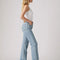 side view of model wearing light wash ribcage straight ankle jeans