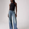 model wearing light denim low loose jeans