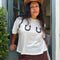 model wearing white cropped relaxed fit tee with black horseshoes on the bust