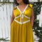 model wearing chartreuse midi dress with white lace accents on the bust, two tie front and ruffle detail on the shoulders
