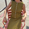 model wearing olive crinkle midi skirt with shaped shell buttons on the top and matching tank