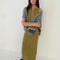 model wearing olive crinkle midi skirt with shaped shell buttons on the top and matching tank